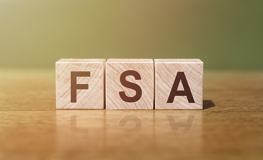 FSA - an abbreviation of wooden blocks with letters. Reflection caption on the mirrored surface of the table.