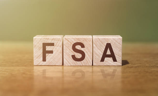 FSA - an abbreviation of wooden blocks with letters. Reflection caption on the mirrored surface of the table. FSA - an abbreviation of wooden blocks with letters. Reflection caption on the mirrored surface of the table. free syrian army stock pictures, royalty-free photos & images