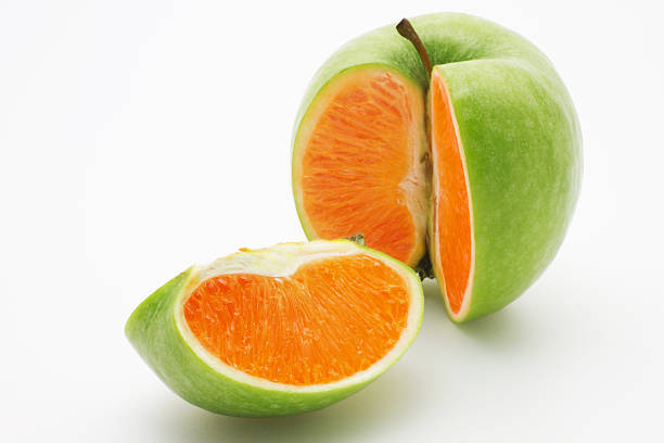 apple com uma laranja - apple fruit surreal bizarre imagens e fotografias de stock