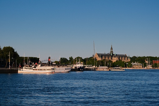 Stockholm, Sweden – June 27, 2023: A scenic view of a harbor with multiple boats parked next to it in Stockholm, Sweden