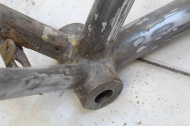 close up of old school bicycle frame with chrome paint on blurred background. suitable for industrial and bicycle theme.