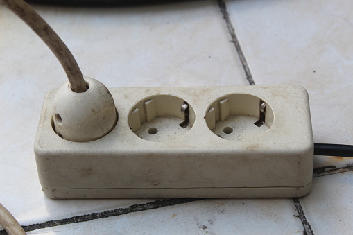 Electrical plug in outlet socket at home