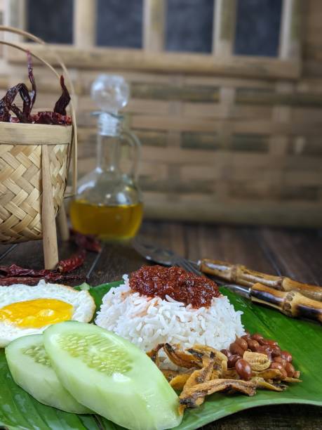 istock Nasi lemak (Malay fragrant rice dish cooked in coconut milk and pandan leaf) with recipe condiment such as chicken, egg and chili paste ready to eat for breakfast or lunch 1566203377