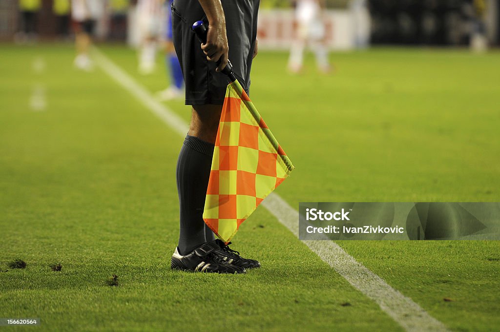 Soccer referee's checkered flag on a soccer field Soccer Referee holding flag Referee Stock Photo