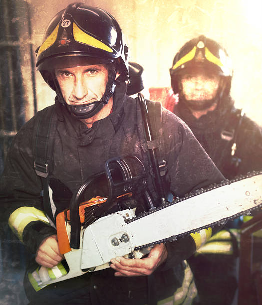 Firefighters with chainsaw in the Wings. Grunge effects added.