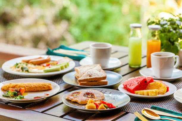 istock Breakfast table near lake in Asian resort. 1566214731