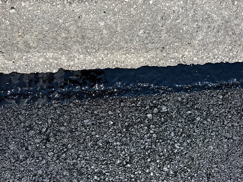 Edge of new tarmac or asphalt on side of road