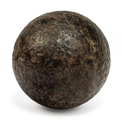 Genuine 18th century cannonball isolated on a white background