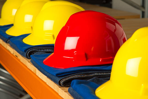 istock Red hat between yellow hats showing who is the boss 156624836