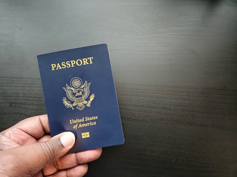 Male Hand Holding A USA Passport