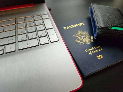 Close Up of Passport, Laptop and Wallet