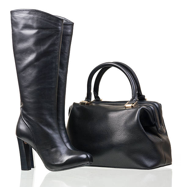 istock Women high-heeled boots and leather bag over white 156628436