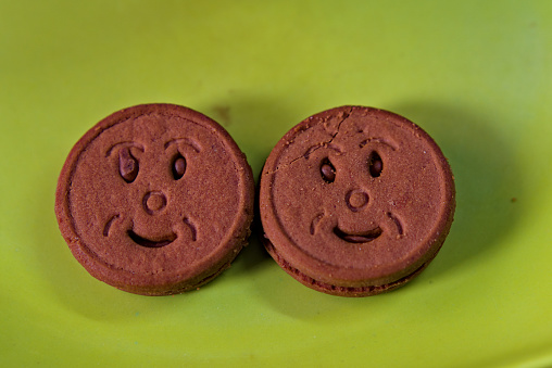 a pair of smiley shaped brown biscuits