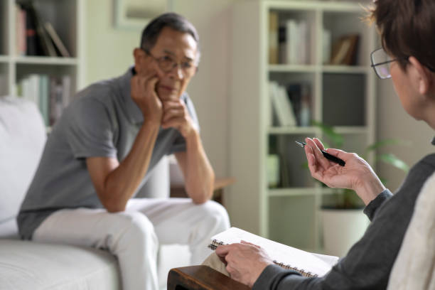 istock Senior patient with mental health problem talking and consulting therapist 1566294397