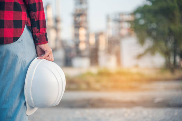 istock Engineer woman hands holding hardhat white work helmet hard hat for Construction Engineering. Refinery woman engineer oil industry hands hold worker helmet hard hat. Refinery industry engineering 1566294414