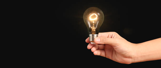 istock Humans hold light bulbs in hand innovative technology 1566299184