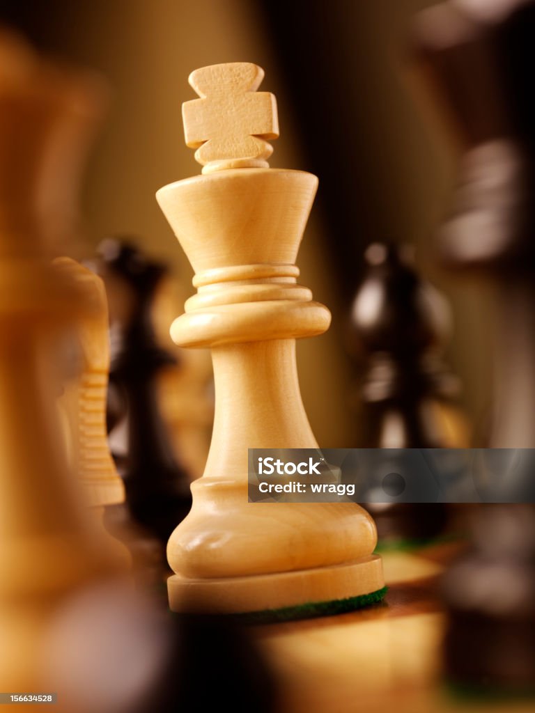 Wooden Chess King King in a game of chess, stands out from the rest. Achievement Stock Photo
