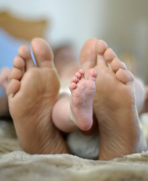 istock Mothers feet and babies foot 156641226