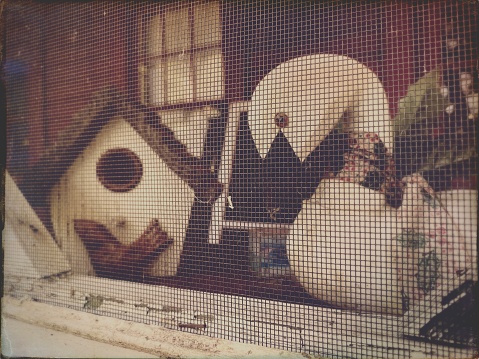 Bird House and Swan Planter behind a Screen