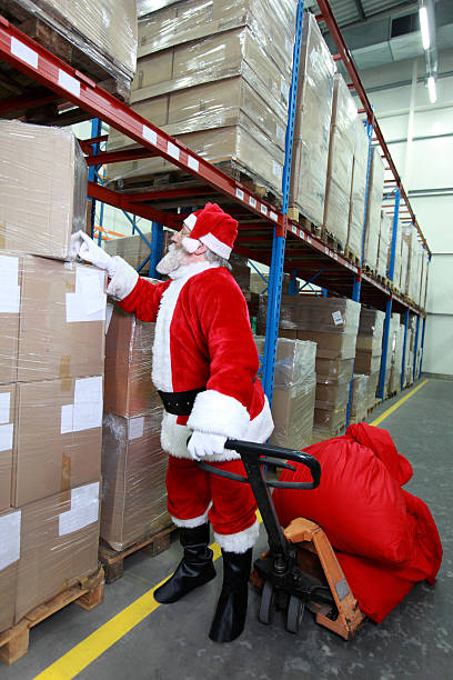 istock Santa claus looking for presents in storehouse 156643562