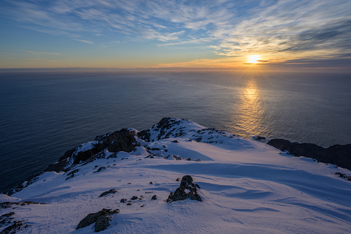 View from the mountain Qaqqartivakajik over the atlantic ocean at sunset. It is located in East Greenland.