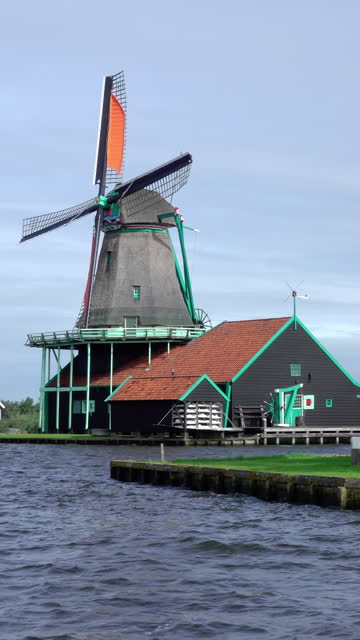 Vintage Windmill on the Bank of the Dutch Canal. Vertical Video