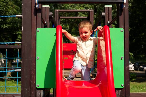 istock Little toddler playing on the playground 1566487504