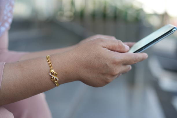 A woman's hand holds a cell phone