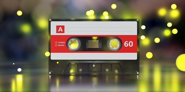 Black vintage audio cassette tape on bokeh lights background, Retro music party. 3d render