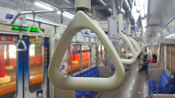 istock View of handles on ceiling rails for standing passenger. Handle on the commuter line train, prevent toppling. View inside the commuter line train carriage. 1566495842