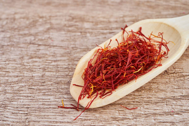 istock red crocus sativus saffron spice in wood scoop on wooden table background. red crocus sativus saffron spice table background. food spice red crocus sativus saffron spice table background 1566519308