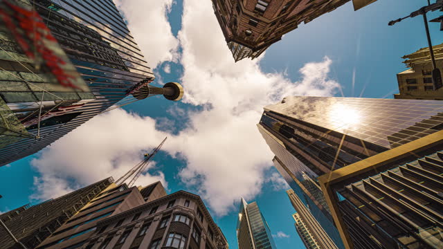 4K Footage Time lapse Low angle of tall Business buildings skyscraper with reflection with clouds among high buildings center in Central Business district of Sydney