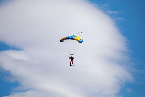Parachute in the sky. Skydiver is flying a parachute in the blue sky. High quality photo