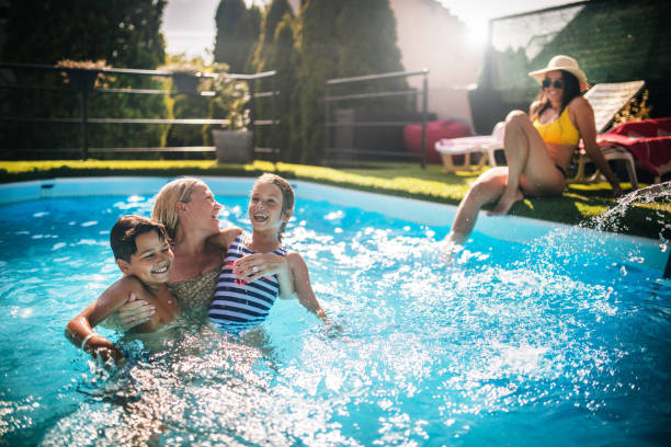 istock multi generation family enjoying at pool  party at home 1566565629