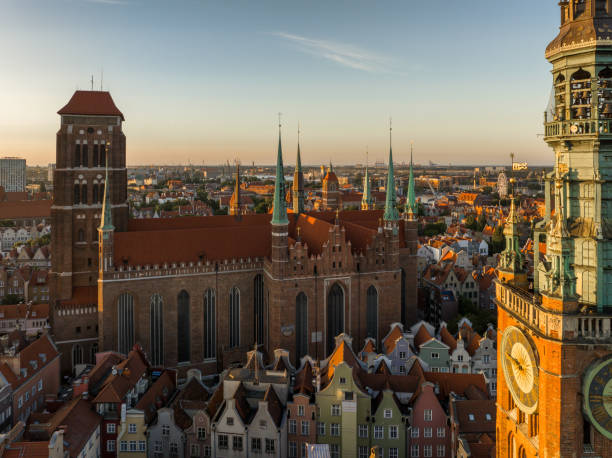 The tower of the city hall of Gdańsk and St. Mary's Basilica in the background. Wieża ratuszowa urzędu miasta Gdańska a w tle Bazylika Mariacka. gdansk city stock pictures, royalty-free photos & images