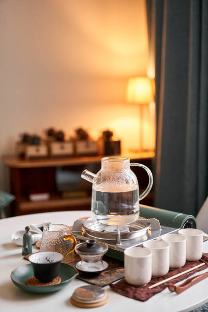 istock Brewing white tea in a transparent teapot. Everything is ready for the tea ceremony. The ceremony is according to all the rules, but not in the classical style. Adapted to a modern apartment. 1566575182