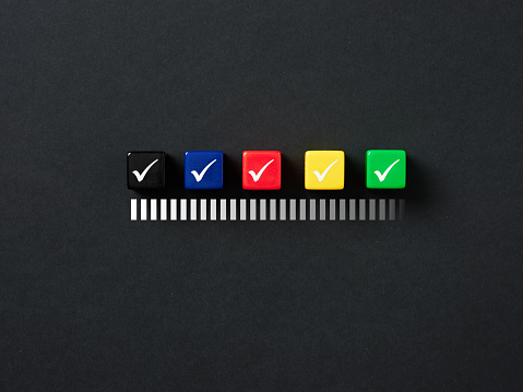 Successful completion of business tasks. Getting the necessary permissions. Completing the procedures. Verification progress. Checkmark symbols on colorful cubes on black background.