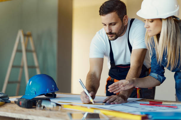 istock Drawing measurements on housing plan at construction site! 1566599839