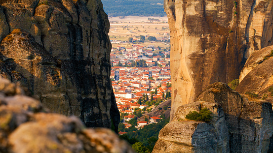 Scenic view of Meteora monastery and cityscape against mountain during sunny day