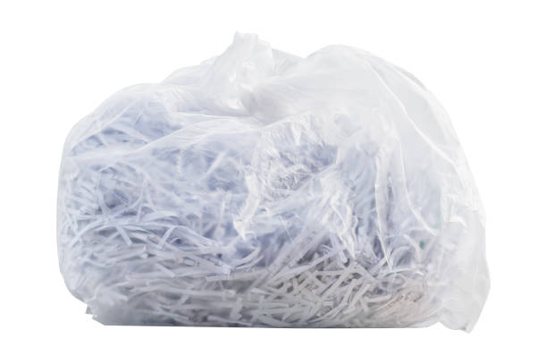 istock Shredding paper in white garbage bag isolated on white background with clipping path 1566621872