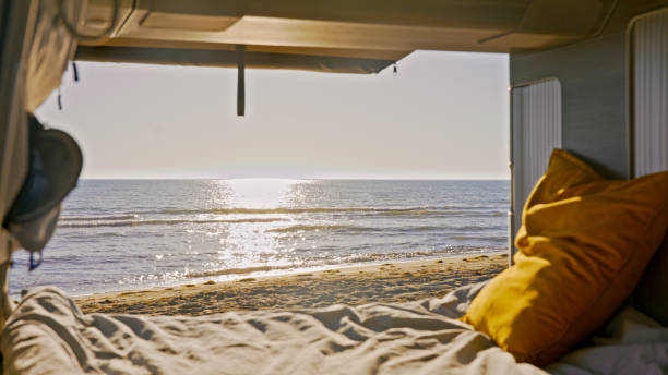 istock Beautiful seascape from camper van on bright sunny day 1566641000