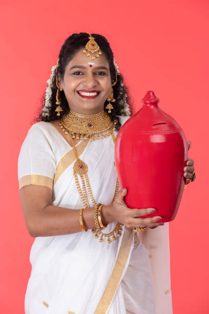young south indian woman saves money in piggy bank - women savings uk coin imagens e fotografias de stock