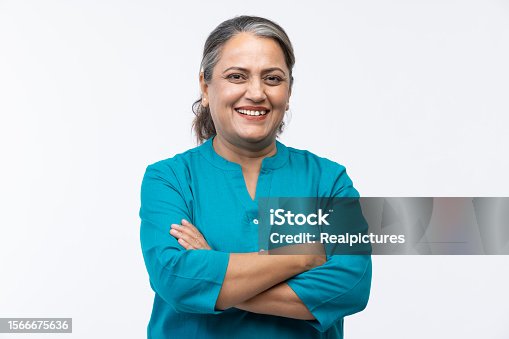 istock Portrait of confident mature woman wearing formalwear with arms crossed standing against white background 1566675636