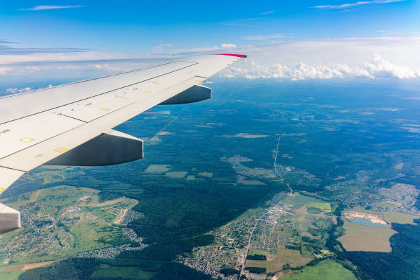 istock View from the airplane window at a beautiful cloudy sky and the airplane wing 1566680754