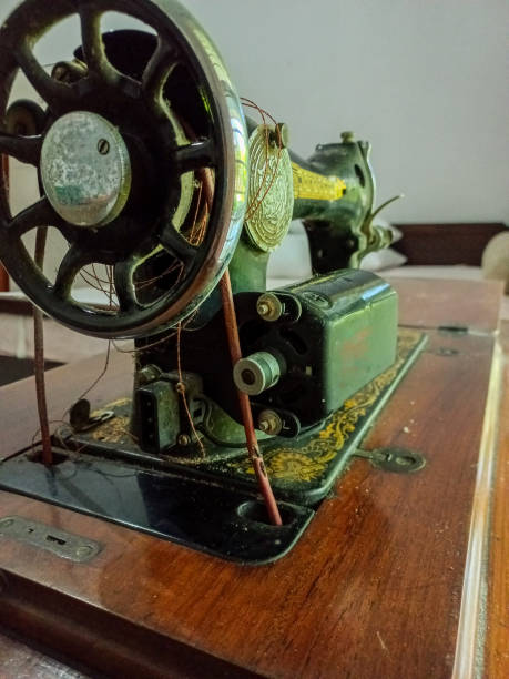 istock Vintage sewing machine on a wooden desk 1566684535