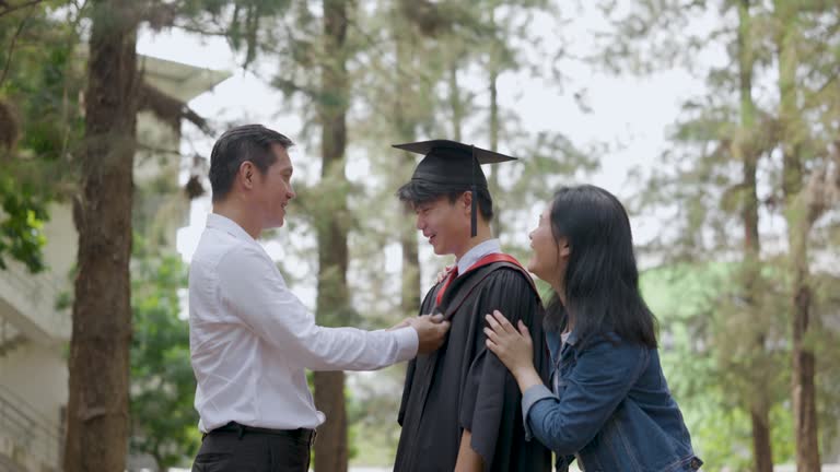 Asian college student preparing for graduation ceremony