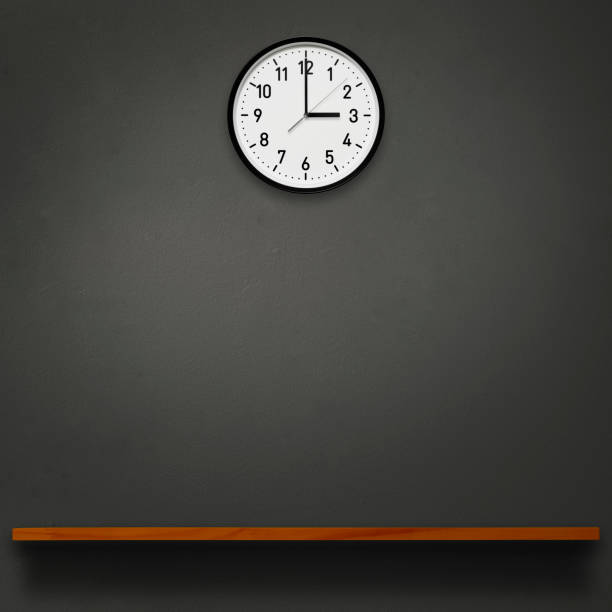 istock 3 O'Clock wall clock above the wooden shelf 1566699373
