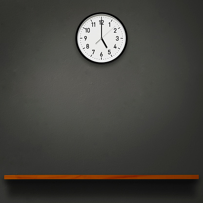 5 O'Clock wall clock above the wooden shelf on dark concrete wall with copy space.
9 to 5