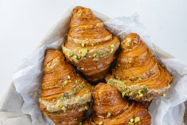 istock Rustic basket of croissants on white table 1566702039