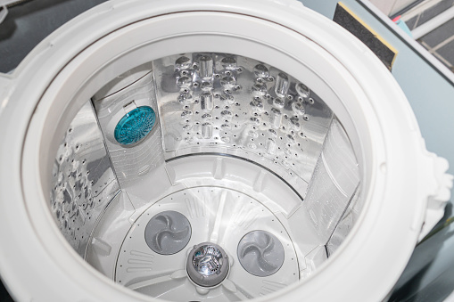 Inside of the washer drum is completely clean,free from dirt stains and musty odors,top-loading washing machine,household electrical appliances,cleaning services,cleanliness and hygienic concept